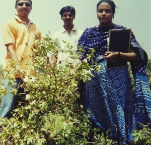 Devparna, with two farmers, amidst fieldwork in India